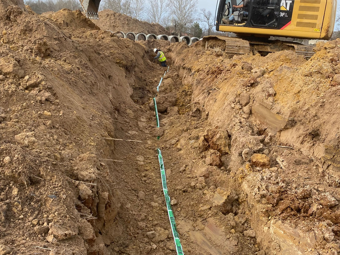 Utility trench with pipe and site materials